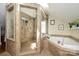Bathroom featuring tiled shower, soaking tub, and a skylight for natural lighting at 139 S Laurel Ave, Charlotte, NC 28207