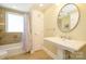 Bathroom featuring a modern sink, mirror, and tiled shower/tub with neutral colors at 139 S Laurel Ave, Charlotte, NC 28207