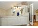 Bathroom with double sink vanity, white cabinets, stylish lighting, and a separate water closet at 139 S Laurel Ave, Charlotte, NC 28207