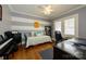 Bright bedroom with wood floors, daybed, and ceiling fan is a welcoming space at 139 S Laurel Ave, Charlotte, NC 28207