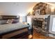 Cozy bedroom with a stone fireplace, wood floors, and natural light at 139 S Laurel Ave, Charlotte, NC 28207