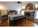 Bedroom with wood floors, stone fireplace, and modern bed and bedding at 139 S Laurel Ave, Charlotte, NC 28207