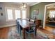Spacious dining room featuring a large table, colorful rug, and access to the living room at 139 S Laurel Ave, Charlotte, NC 28207