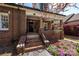 Inviting brick home showcasing a cozy front porch, manicured landscaping and vibrant flowerbeds at 139 S Laurel Ave, Charlotte, NC 28207
