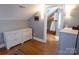 Attic hallway featuring closet, storage, and door to bathroom with tiled shower at 139 S Laurel Ave, Charlotte, NC 28207