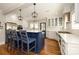 Chic kitchen with a blue island, white cabinetry, stainless steel appliances, and hardwood floors throughout at 139 S Laurel Ave, Charlotte, NC 28207