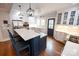Bright kitchen boasts white cabinets, quartz countertops, stainless steel appliances, and a stylish island with seating at 139 S Laurel Ave, Charlotte, NC 28207