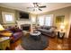 Comfortable living room featuring a stone fireplace, built-in shelving, and hardwood floors at 139 S Laurel Ave, Charlotte, NC 28207