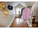 Bright walk-in closet with custom shelving, clothes rack, hardwood floor, and unique vaulted ceiling at 139 S Laurel Ave, Charlotte, NC 28207