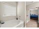 Bright bathroom featuring a soaking tub under a window and a separate shower stall at 1430 Whitman Ct, York, SC 29745