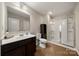 Bathroom featuring a dark vanity, toilet, and glass-enclosed shower, with wood-look flooring at 1430 Whitman Ct, York, SC 29745