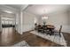 Bright dining room featuring hardwood floors, decorative rug, chandelier, and decorative wainscoting at 1430 Whitman Ct, York, SC 29745
