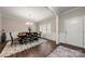 Dining area showcasing hardwood floors, bright windows, decorative wainscoting, and a decorative rug at 1430 Whitman Ct, York, SC 29745