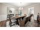 Dining area featuring hardwood floors, chandelier, decorative rug, and a dining table with chairs and bench at 1430 Whitman Ct, York, SC 29745