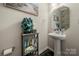 Cozy half bathroom featuring pedestal sink, decorative mirror, and decorative shelving at 1430 Whitman Ct, York, SC 29745