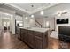 Spacious kitchen island with granite countertops and dark wood cabinetry, perfect for meal preparation and seating at 1430 Whitman Ct, York, SC 29745