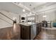 Open kitchen view with granite island, stainless steel appliances, and hardwood floors at 1430 Whitman Ct, York, SC 29745