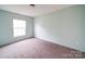 Serene bedroom with soft carpet, a bright window, and fresh paint providing a relaxing atmosphere at 1459 Wehunt Store Rd, Cherryville, NC 28021