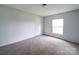 Simple bedroom with neutral carpet, a bright window, and fresh paint providing a calm atmosphere at 1459 Wehunt Store Rd, Cherryville, NC 28021