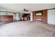 Open-concept living room boasts a cozy fireplace, ceiling fan and seamless flow into the kitchen at 1459 Wehunt Store Rd, Cherryville, NC 28021