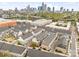 Beautiful aerial view of townhomes with a downtown skyline in the background, and community parking at 15041 New Amsterdam Ln, Charlotte, NC 28204