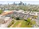 City neighborhood featuring townhomes, green spaces, a track, and the skyline in the distance at 15041 New Amsterdam Ln, Charlotte, NC 28204