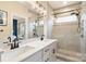 Bathroom featuring a double sink vanity, large mirror, glass shower enclosure, and modern fixtures at 15041 New Amsterdam Ln, Charlotte, NC 28204