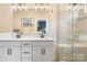 Bathroom featuring a double vanity, a large mirror, and a glass-enclosed shower with tile surround at 15041 New Amsterdam Ln, Charlotte, NC 28204
