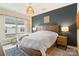 Cozy bedroom featuring a king-size bed, accent wall, bedside tables, and neutral decor at 15041 New Amsterdam Ln, Charlotte, NC 28204