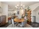 Elegant dining area adjacent to the kitchen, featuring a modern chandelier at 15041 New Amsterdam Ln, Charlotte, NC 28204