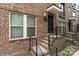 Close up exterior showcasing brick facade, black door and stairs to entry at 15041 New Amsterdam Ln, Charlotte, NC 28204