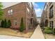 Charming townhome exterior featuring landscaped walkway and brick facade at 15041 New Amsterdam Ln, Charlotte, NC 28204