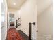 Hallway leading to bedroom with carpet and hardwood floors, natural lighting at 15041 New Amsterdam Ln, Charlotte, NC 28204