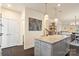 Open concept kitchen features a large island with granite countertops and stainless steel appliances at 15041 New Amsterdam Ln, Charlotte, NC 28204