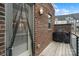 Charming deck with brick facade, an outdoor grill, and view of neighboring houses, offering a private outdoor space at 15041 New Amsterdam Ln, Charlotte, NC 28204