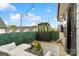 Inviting outdoor patio with a fire pit, string lights, seating and decorative greenery and patio with black and white rug at 15041 New Amsterdam Ln, Charlotte, NC 28204