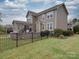 Well-maintained backyard with a black metal fence, spacious lawn, and a patio area at 15211 Windward Ln, Lancaster, SC 29720