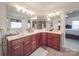 Bathroom features a double sink vanity with dark wood cabinets and large mirrors at 15211 Windward Ln, Lancaster, SC 29720