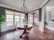 Bright dining room with hardwood floors, large windows, and a decorative centerpiece at 15211 Windward Ln, Lancaster, SC 29720