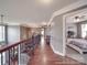 Hardwood hallway overlooking the staircase and fireplace, with bedroom in view at 15211 Windward Ln, Lancaster, SC 29720