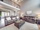 Inviting living room featuring soaring ceilings, a cozy fireplace, and comfortable seating arrangement at 15211 Windward Ln, Lancaster, SC 29720