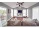 Cozy living room with hardwood floors, a ceiling fan, and large windows that let in plenty of natural light at 15211 Windward Ln, Lancaster, SC 29720