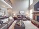 Bright living room with a fireplace, high ceilings, hardwood floors, and comfortable furnishings at 15211 Windward Ln, Lancaster, SC 29720