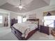 Comfortable primary bedroom with tray ceilings, soft carpet, and windows that provide plenty of natural light at 15211 Windward Ln, Lancaster, SC 29720
