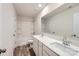 Bright bathroom features a double sink vanity, white cabinets, shower-tub combination, and wood-look floors at 1526 Cottage Creek Dr, Bessemer City, NC 28016