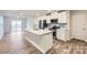 Modern kitchen with stainless steel appliances, white cabinets, and a center island with a sink at 1526 Cottage Creek Dr, Bessemer City, NC 28016
