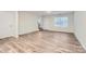 Spacious living room with hardwood floors and ample natural light from a window and glass door at 1526 Cottage Creek Dr, Bessemer City, NC 28016