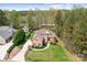 Aerial view of a beautiful brick home with a manicured front lawn and circle driveway at 164 Crooked Branch Way, Troutman, NC 28166