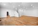 Large basement with wood flooring and white walls featuring staircase and recessed lighting at 164 Crooked Branch Way, Troutman, NC 28166