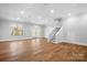 Spacious basement with wood flooring, ample lighting and staircase leading to the upper level at 164 Crooked Branch Way, Troutman, NC 28166